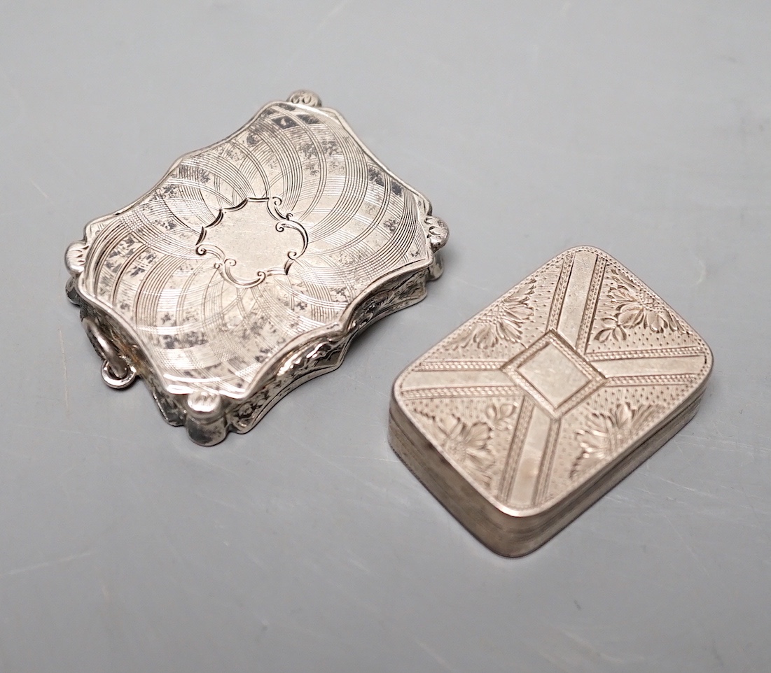 A Victorian engraved silver shaped rectangular vinaigrette, by Nathaniel Mills, Birmingham, 1845, 36mm and a George III silver vinaigrette, London, 1807, 31mm.
